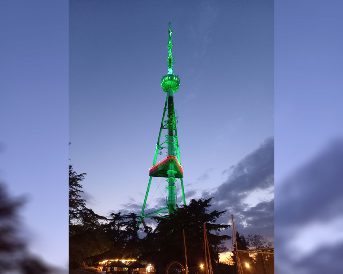 Tbilisi television tower painted in the colors of the flag of Turkmenistan