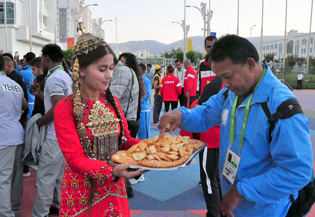 The flags of five countries participating in the Games are hoisted in the Olympic village