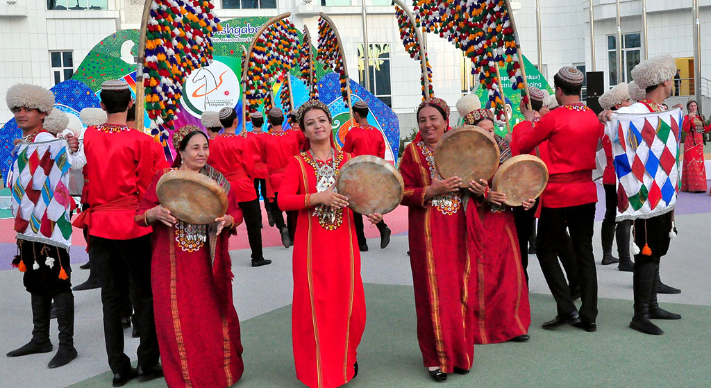 The flags of five countries participating in the Games are hoisted in the Olympic village