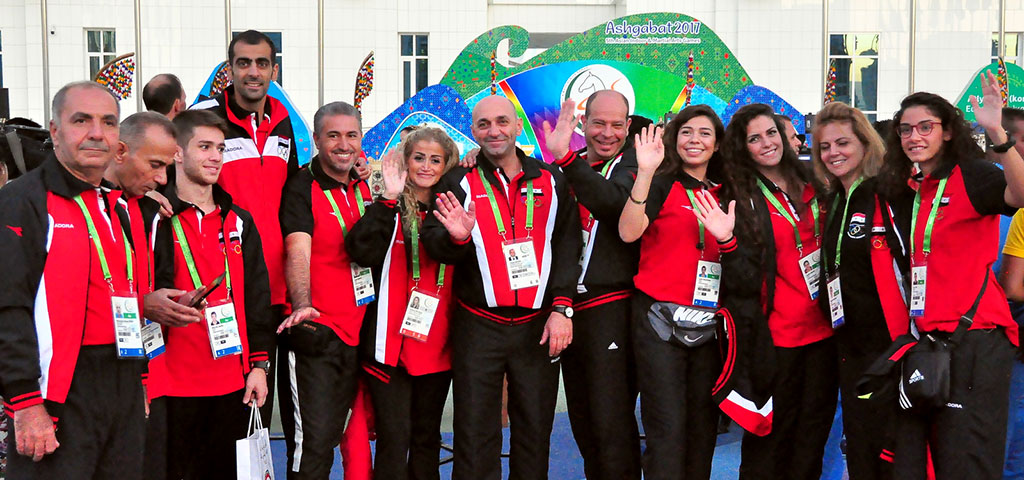 The flags of five countries participating in the Games are hoisted in the Olympic village