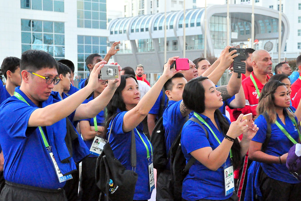 The flags of five countries participating in the Games are hoisted in the Olympic village