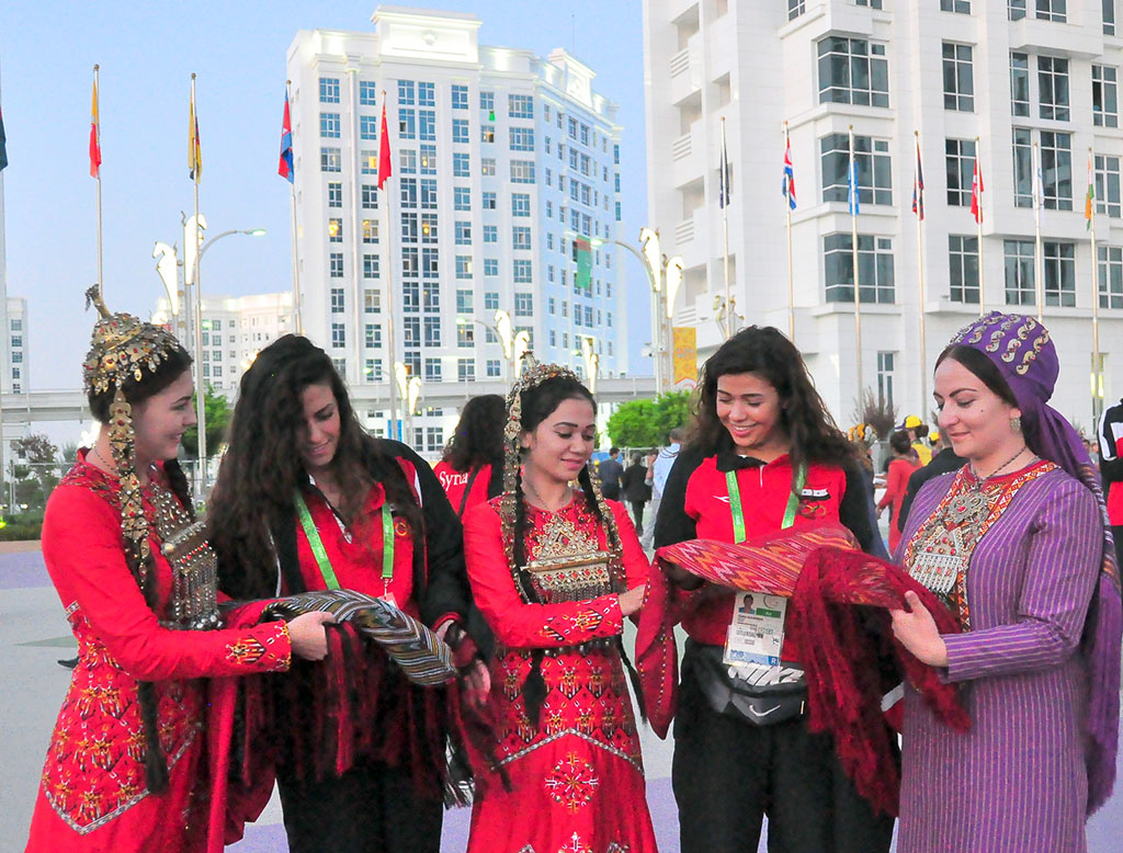 The flags of five countries participating in the Games are hoisted in the Olympic village